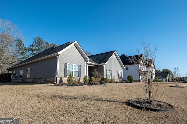 exterior space featuring brick siding and a lawn