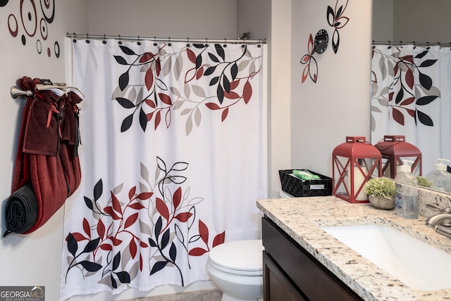 full bathroom with toilet, vanity, and a shower with curtain