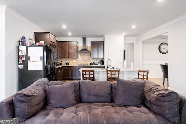 living area with recessed lighting and crown molding