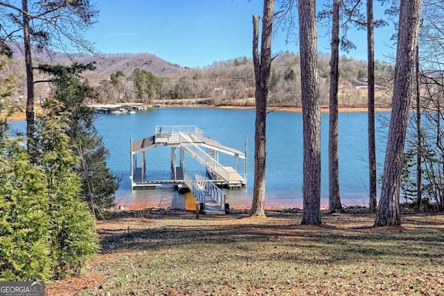 view of dock featuring a water and mountain view