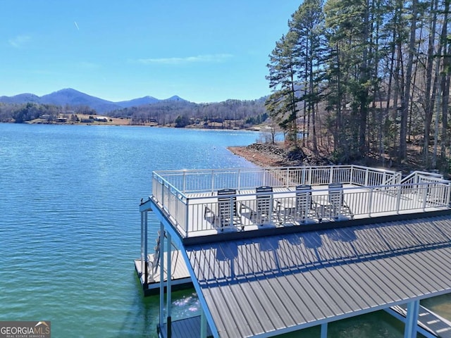 view of dock featuring a water and mountain view