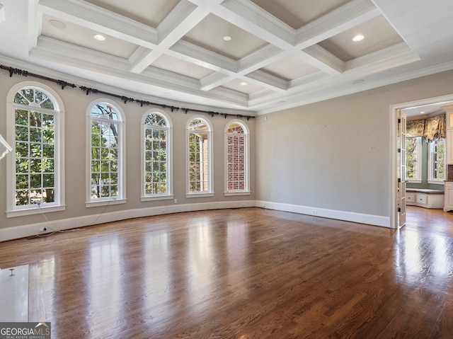 spare room with beamed ceiling, coffered ceiling, wood finished floors, and baseboards