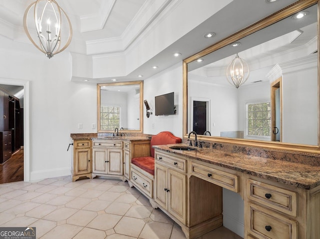 full bathroom featuring plenty of natural light, ornamental molding, a notable chandelier, and vanity