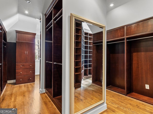 spacious closet featuring lofted ceiling and wood finished floors