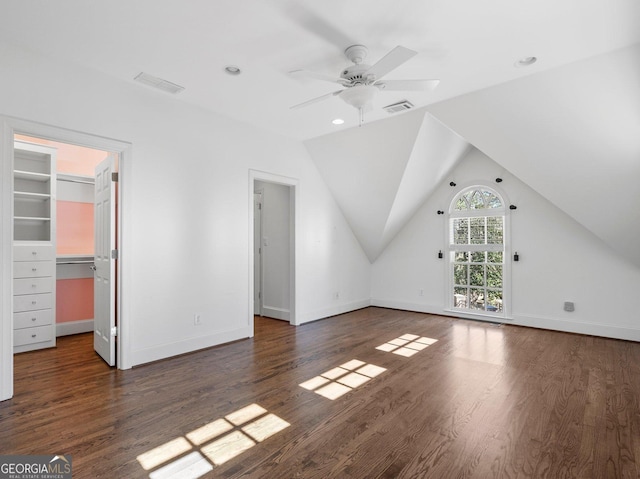 additional living space with visible vents, vaulted ceiling, baseboards, and wood finished floors