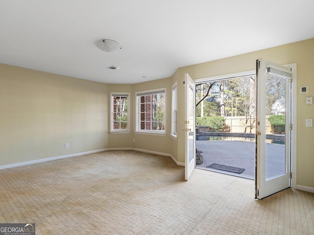 interior space with baseboards, carpet, and a healthy amount of sunlight