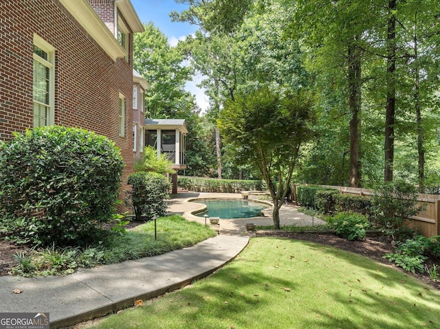 view of yard featuring fence and a fenced in pool