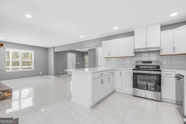 kitchen with under cabinet range hood, stainless steel appliances, a peninsula, open floor plan, and marble finish floor