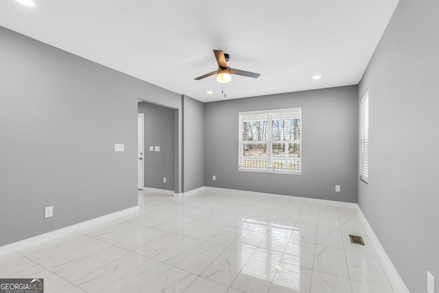 unfurnished room featuring marble finish floor, recessed lighting, a ceiling fan, and baseboards