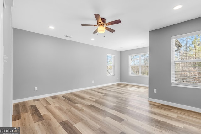 spare room featuring light wood-style flooring, recessed lighting, visible vents, and baseboards