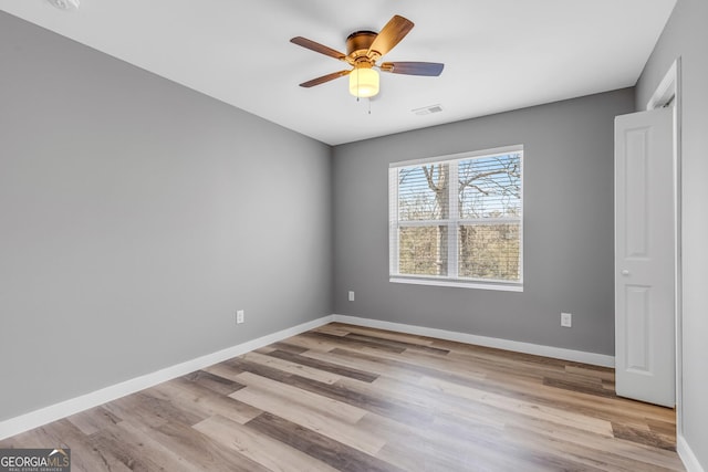 unfurnished bedroom with a ceiling fan, baseboards, and wood finished floors