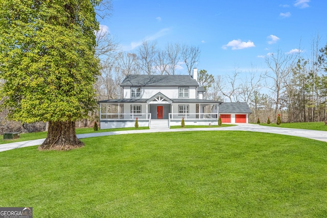 view of front of house with covered porch, driveway, a chimney, and a front lawn