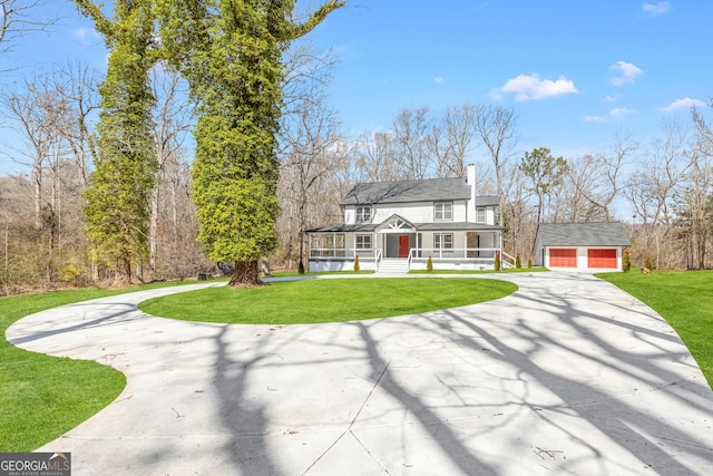 view of front facade with driveway, an outdoor structure, a chimney, and a front lawn