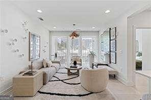 living area featuring plenty of natural light and recessed lighting