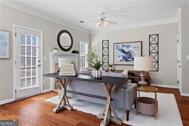 office space with ceiling fan, ornamental molding, and wood finished floors