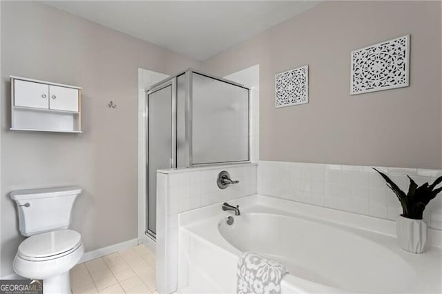 full bath featuring a garden tub, toilet, a stall shower, baseboards, and tile patterned floors