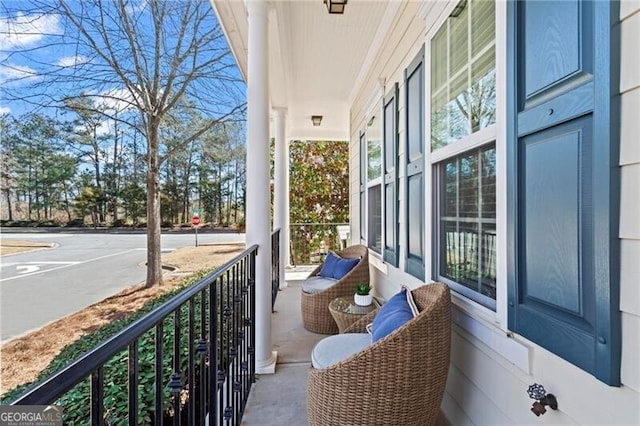 balcony with covered porch and a sunroom