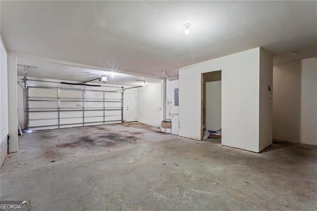 garage featuring electric panel and a garage door opener