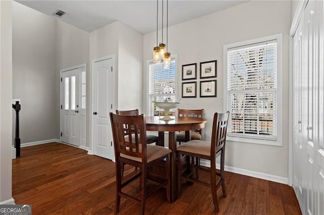 dining room with visible vents, baseboards, and wood finished floors