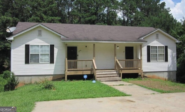 ranch-style house featuring a porch and a front yard