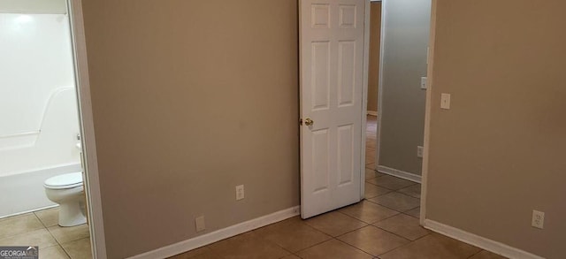 unfurnished bedroom featuring baseboards and tile patterned floors