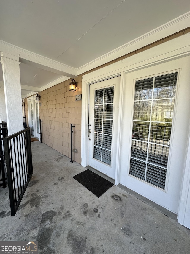 view of exterior entry with concrete block siding