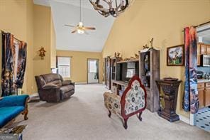 living area featuring a ceiling fan, carpet, and high vaulted ceiling