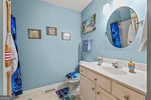 bathroom with vanity, tile patterned floors, toilet, and baseboards