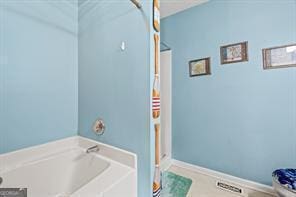 bathroom with a garden tub