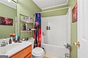 full bath featuring ornamental molding, toilet, vanity, and shower / bath combo