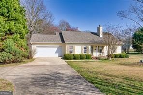 ranch-style house with a front yard, a garage, and driveway