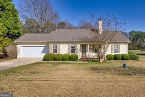 single story home featuring a chimney, concrete driveway, and a garage