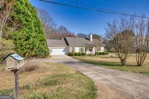 view of front of property featuring aphalt driveway and a garage