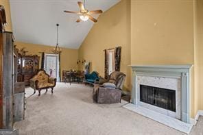 carpeted living room featuring high vaulted ceiling, a high end fireplace, and ceiling fan