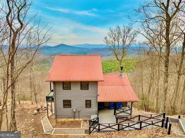 exterior space with metal roof and a mountain view