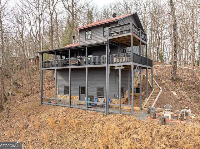 view of front facade featuring stairs and a patio