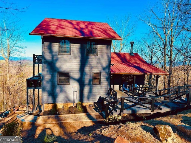 back of house with metal roof