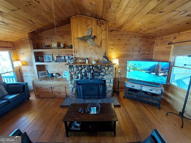 living room with lofted ceiling, wood-type flooring, wood ceiling, and wooden walls