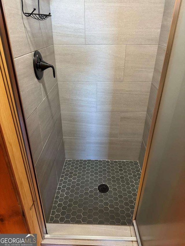 full bath with a shower stall