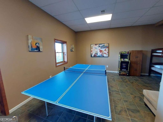 recreation room featuring a drop ceiling, visible vents, and baseboards