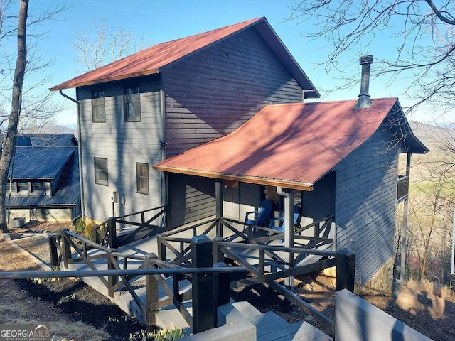 back of property with metal roof