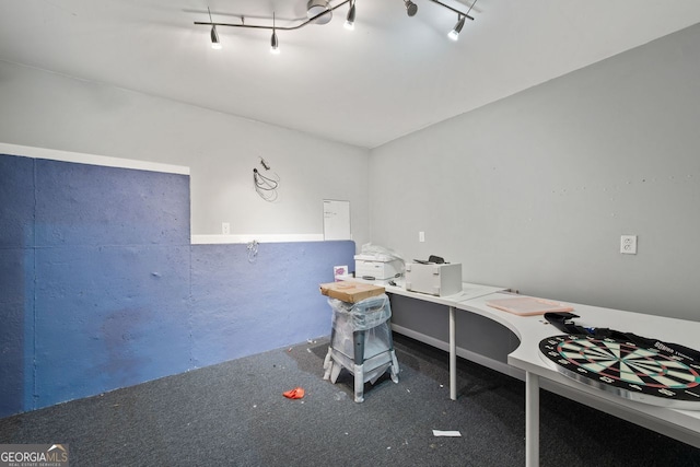 carpeted home office featuring track lighting