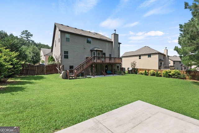 rear view of property featuring a deck, a patio, stairway, and a fenced backyard