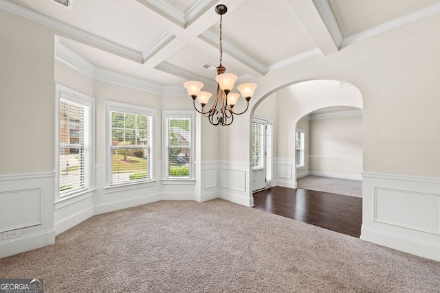 unfurnished dining area with carpet, beam ceiling, a wainscoted wall, a notable chandelier, and coffered ceiling