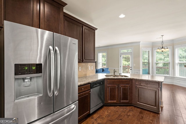 kitchen with stainless steel appliances, plenty of natural light, a sink, and dark wood-style floors