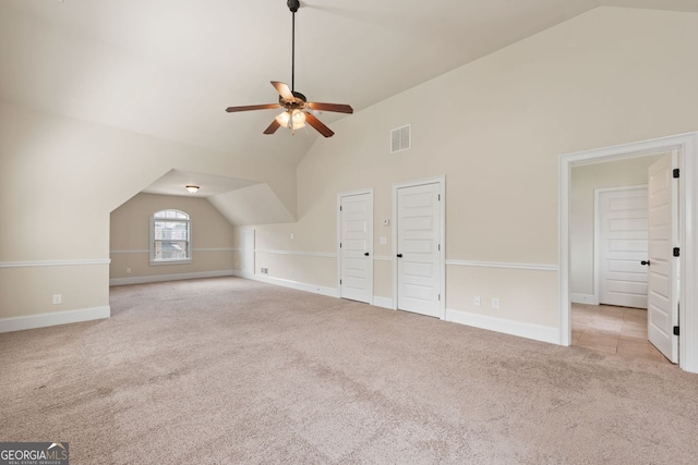 additional living space with carpet, visible vents, a ceiling fan, high vaulted ceiling, and baseboards