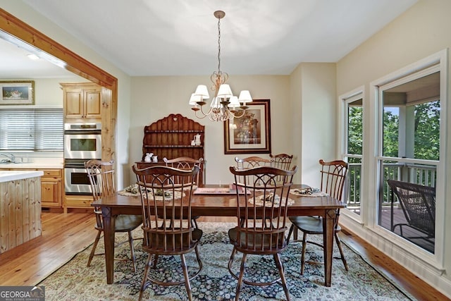 dining area featuring a chandelier and light wood-type flooring