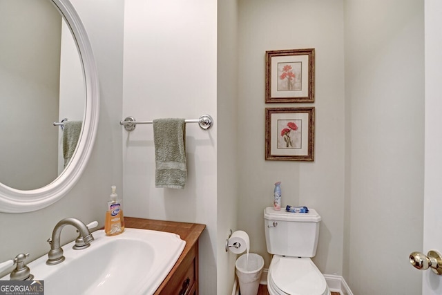 bathroom featuring vanity and toilet