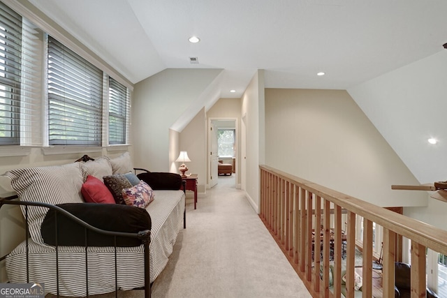 interior space featuring visible vents, baseboards, light colored carpet, lofted ceiling, and recessed lighting