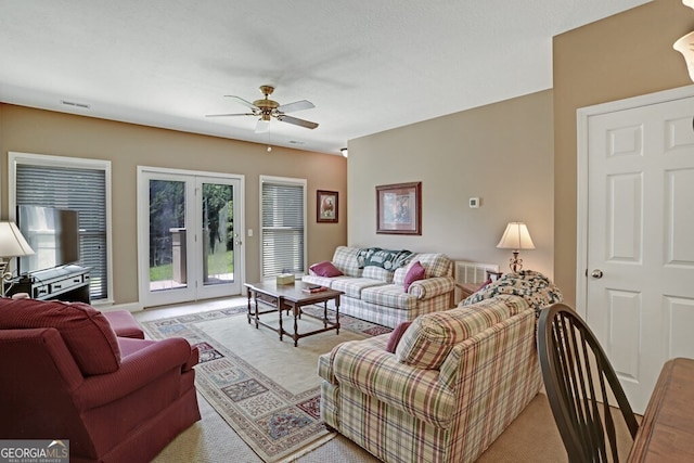 living room with a ceiling fan and visible vents